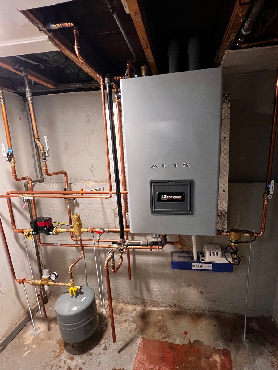 Wall-hung ALTA condensing boiler with copper near-boiler piping in a basement